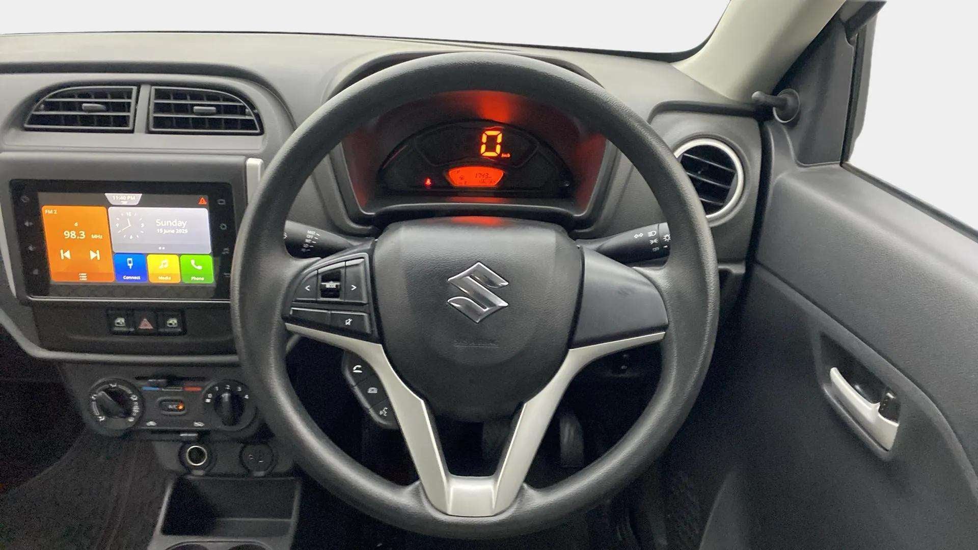 Interior dashboard and steering view of a Maruti Suzuki Alto K10