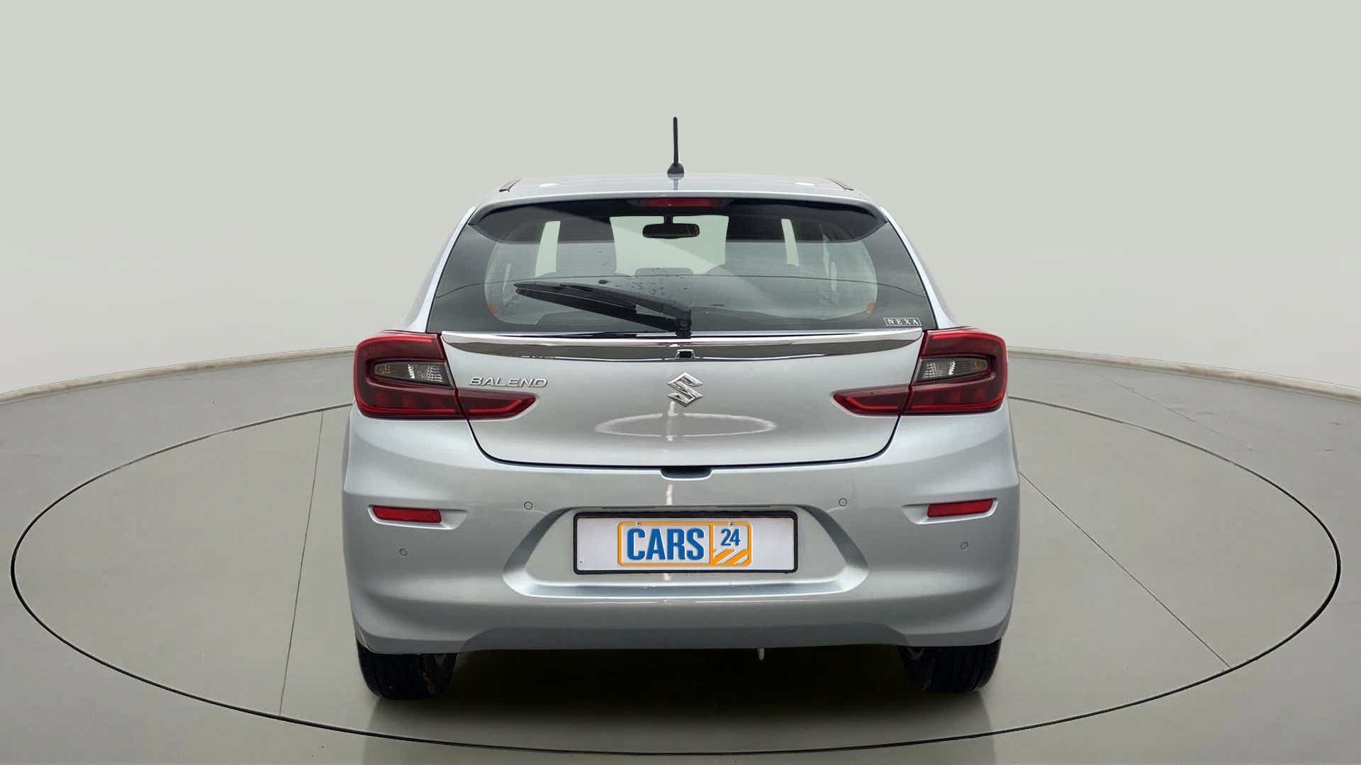 Rear view of a Splendid Silver Maruti Suzuki Baleno