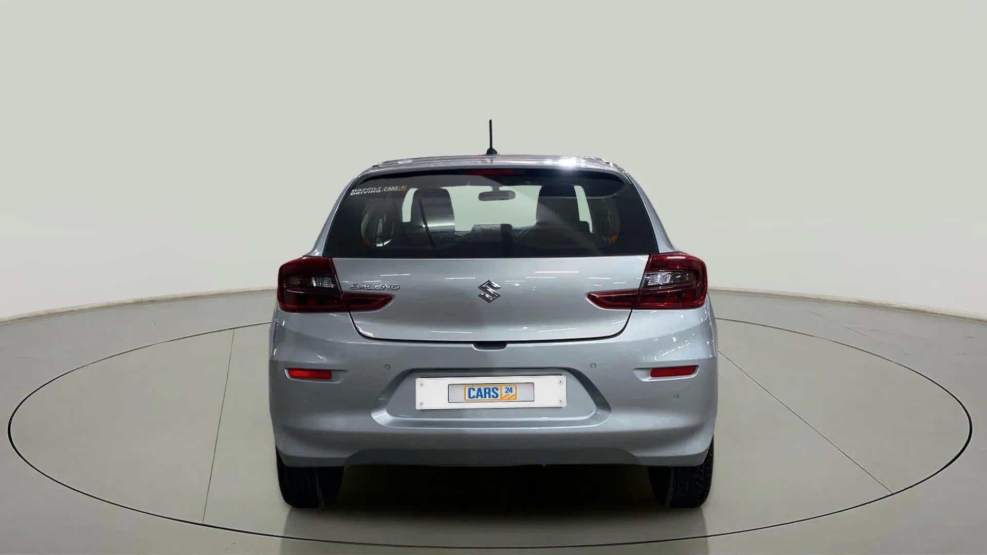 Rear view of a Splendid Silver Maruti Suzuki Baleno