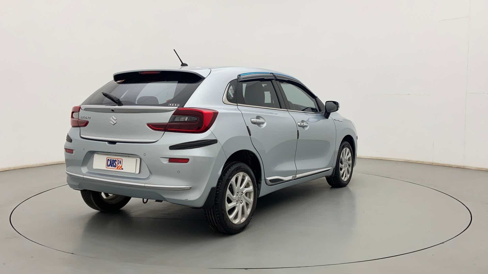 Rear three-quarter view of a Splendid Silver Maruti Suzuki Baleno