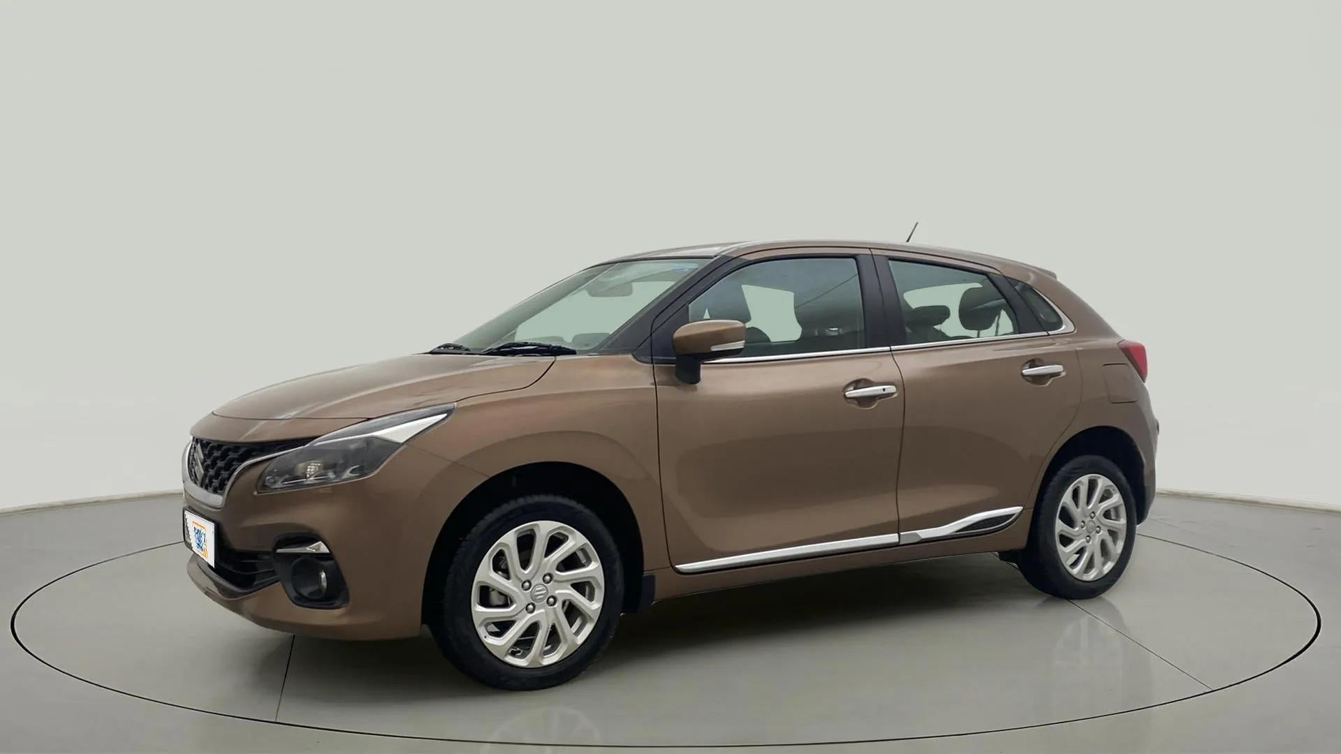 Side view of a luxe beige Maruti Suzuki Baleno