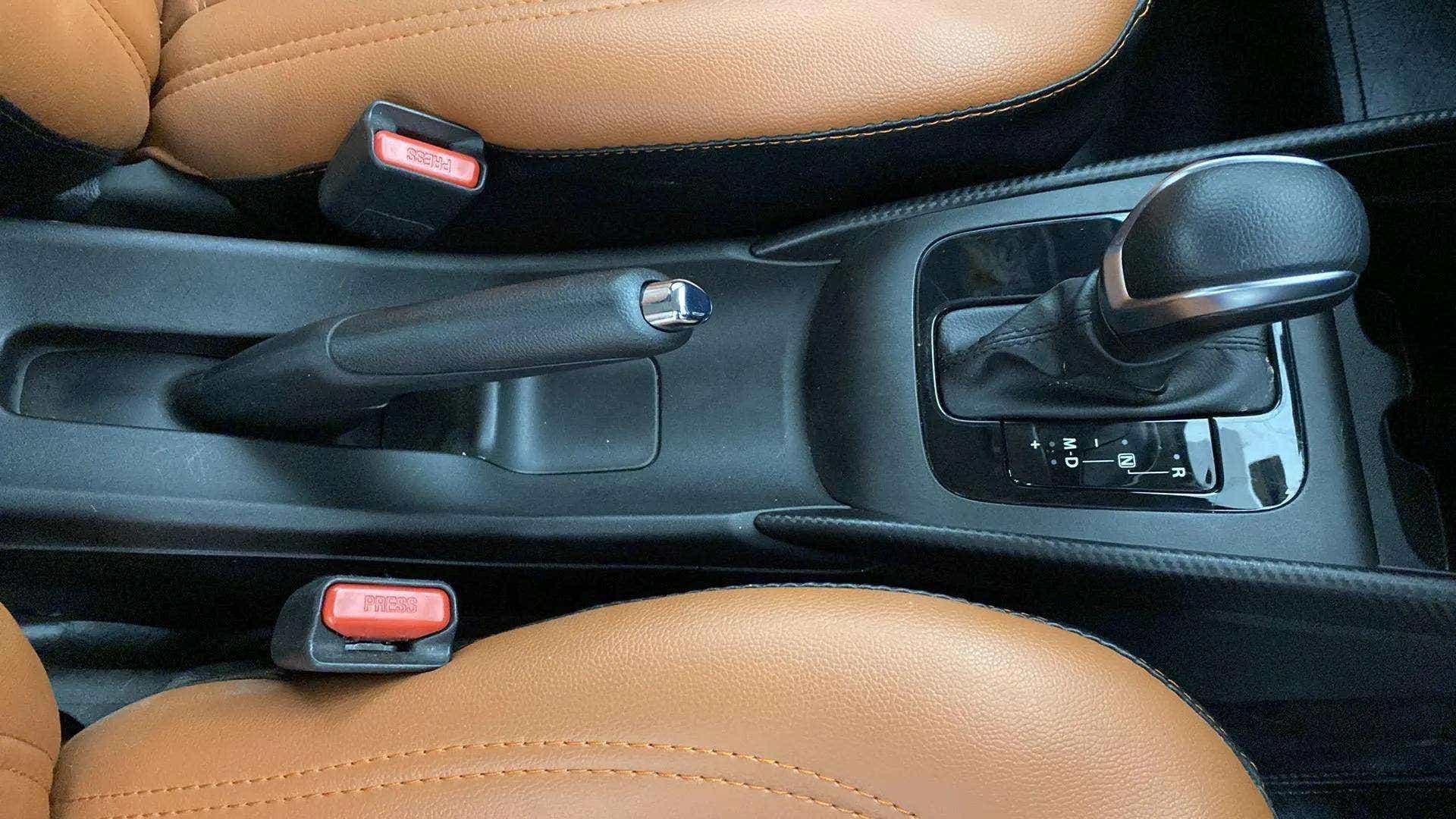 Center console with gear shifter and handbrake of a Maruti Suzuki Baleno
