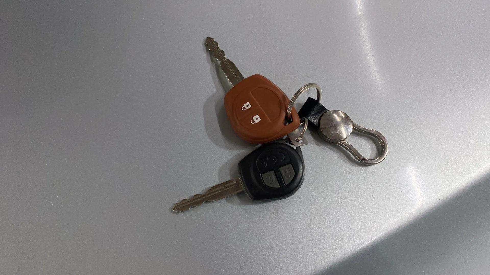 Car keys on the hood of a Maruti Suzuki Baleno