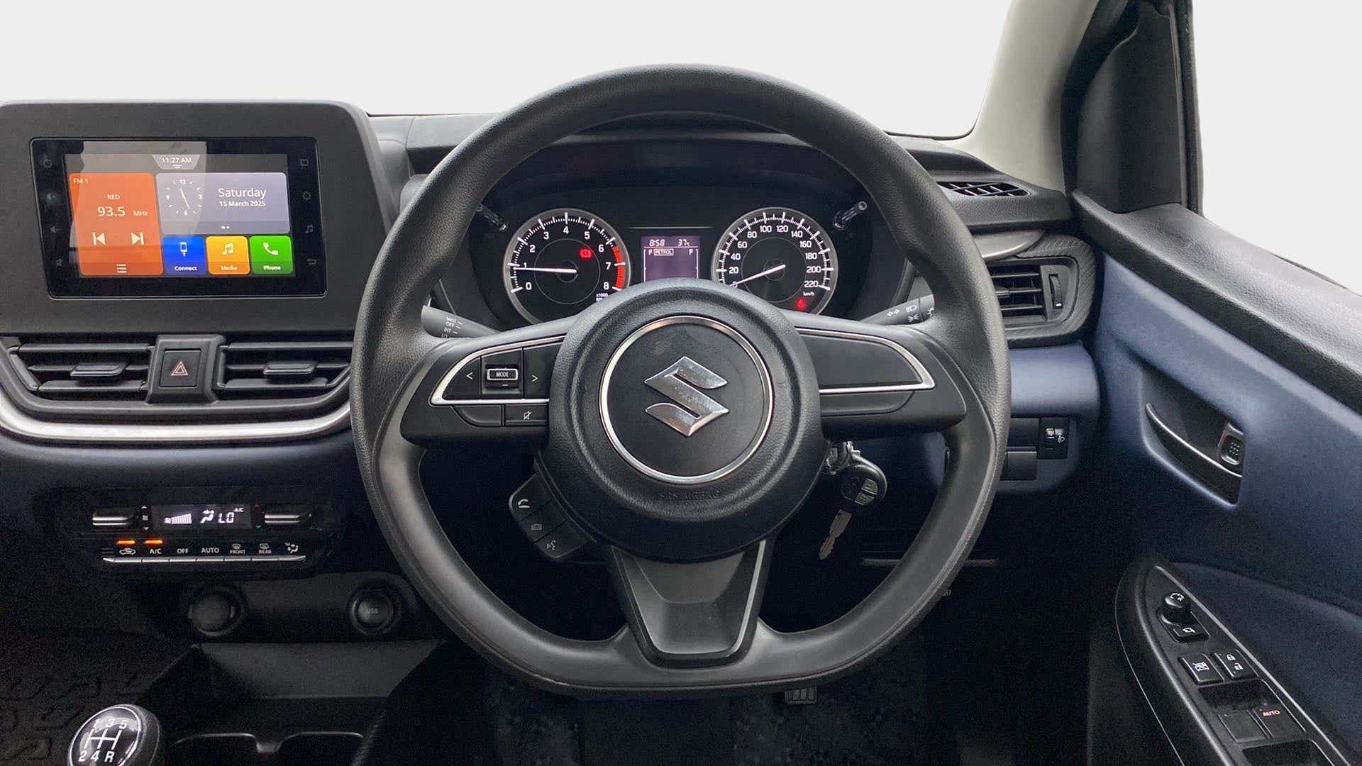 Interior dashboard and steering wheel of a Maruti Suzuki Baleno