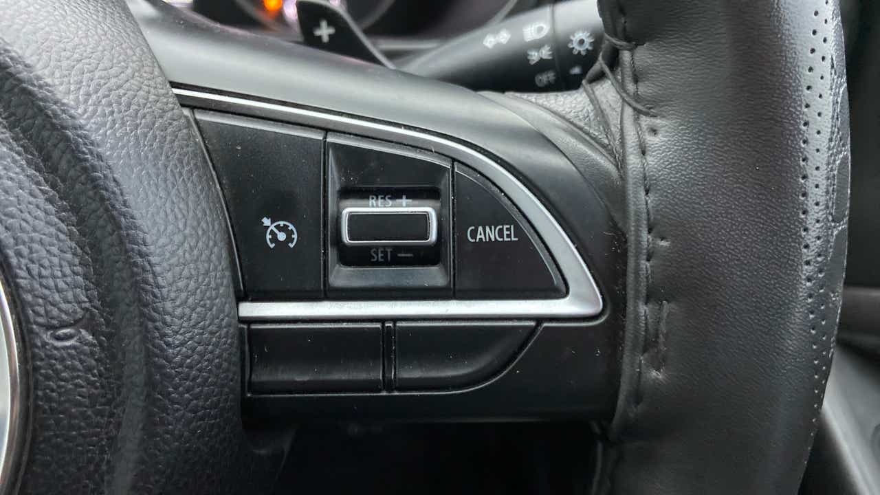 Steering wheel cruise control buttons of a Maruti Suzuki Brezza