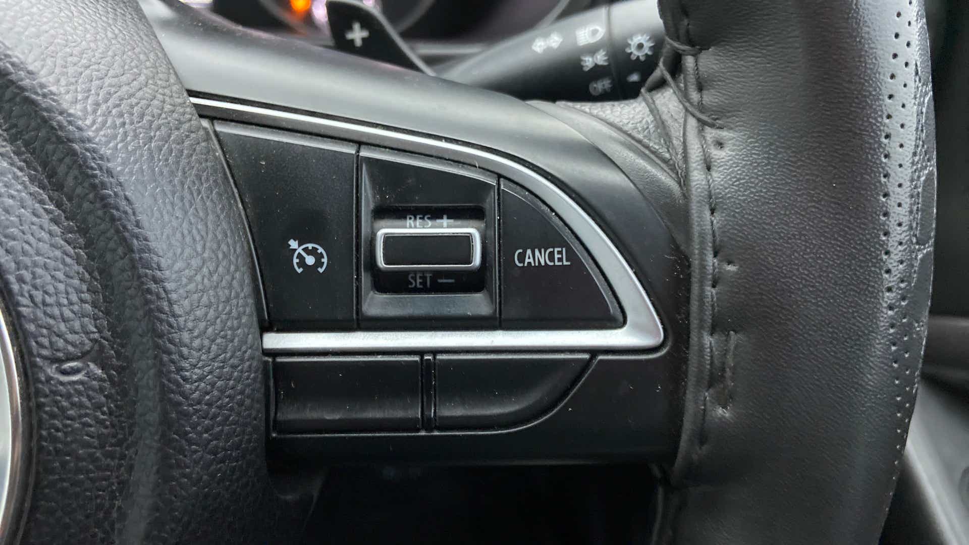 Steering wheel cruise control buttons of a Maruti Suzuki Brezza