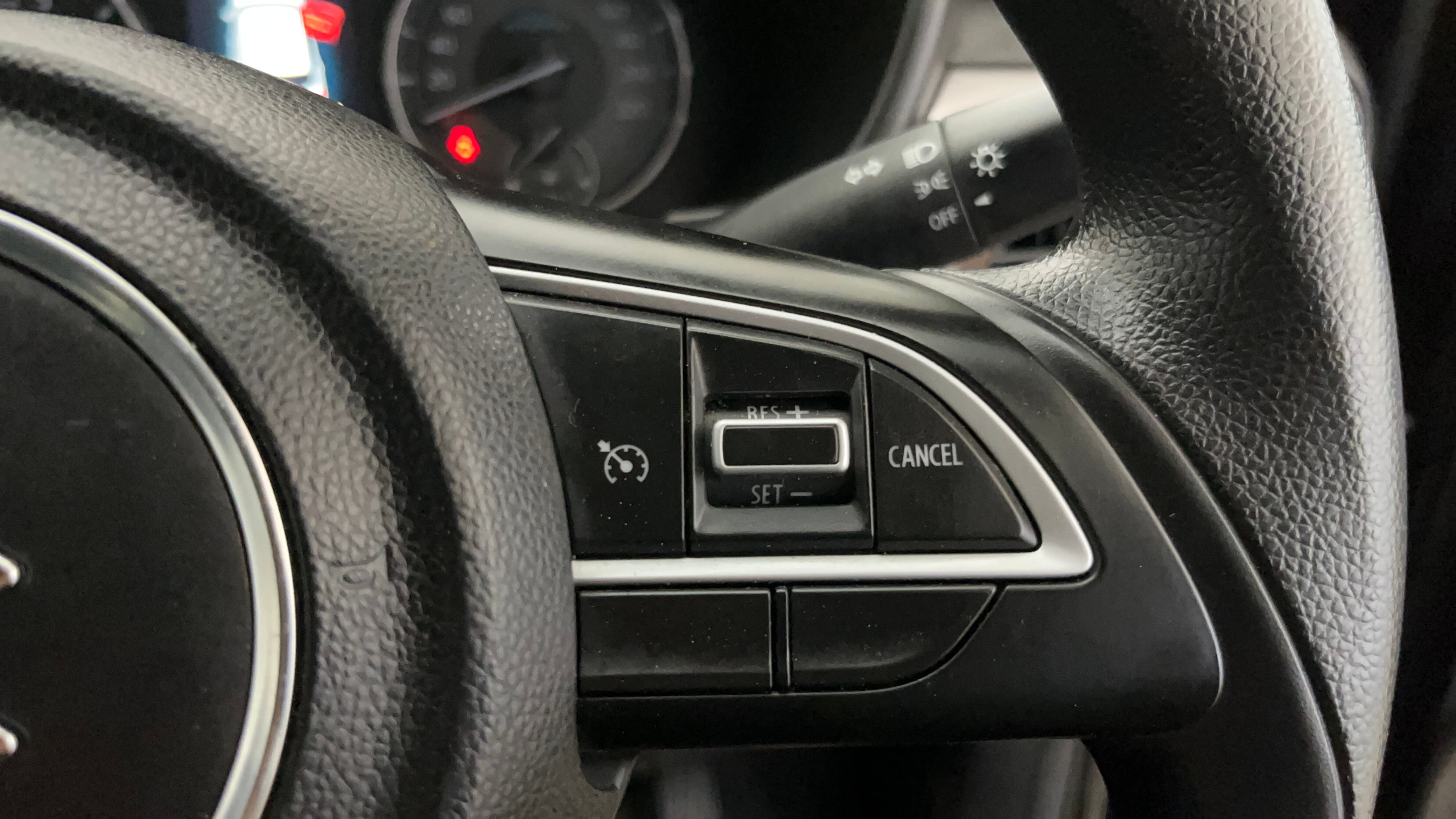 Cruise control buttons on a Maruti Suzuki Brezza steering wheel