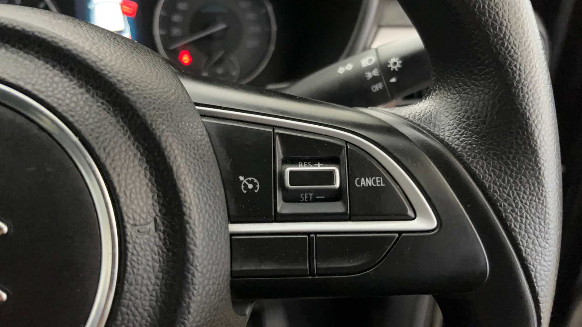 Cruise control buttons on a Maruti Suzuki Brezza steering wheel