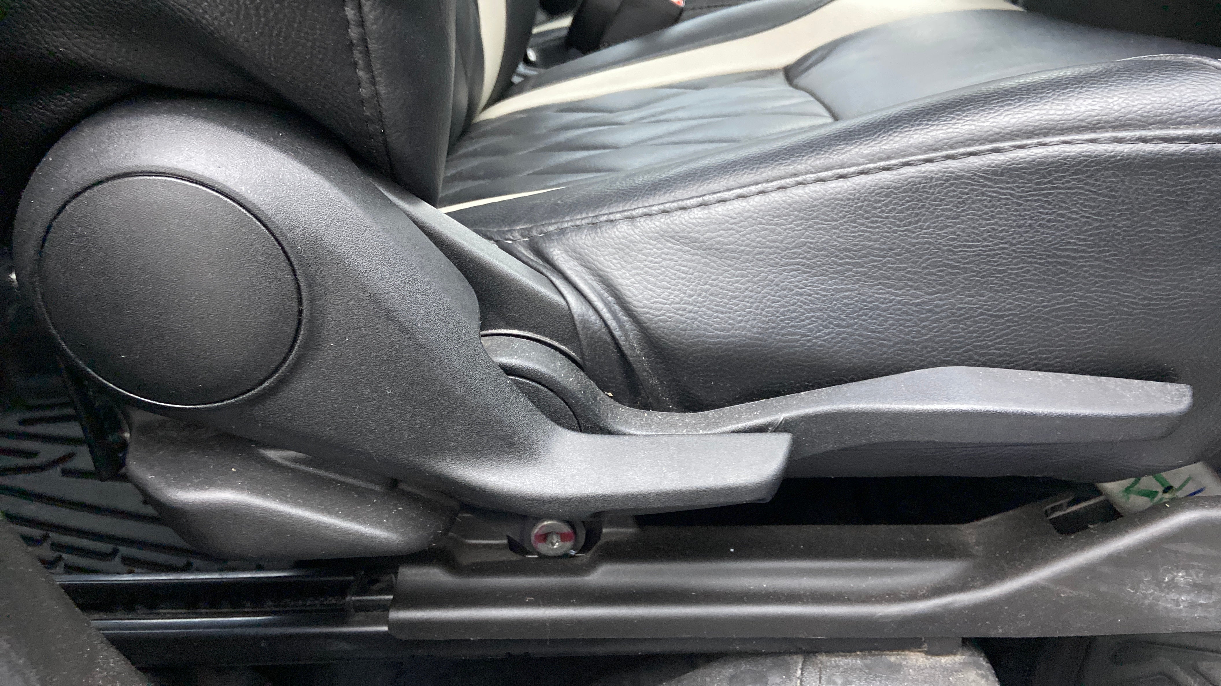 Seat height adjuster lever close-up of a Maruti Suzuki Brezza