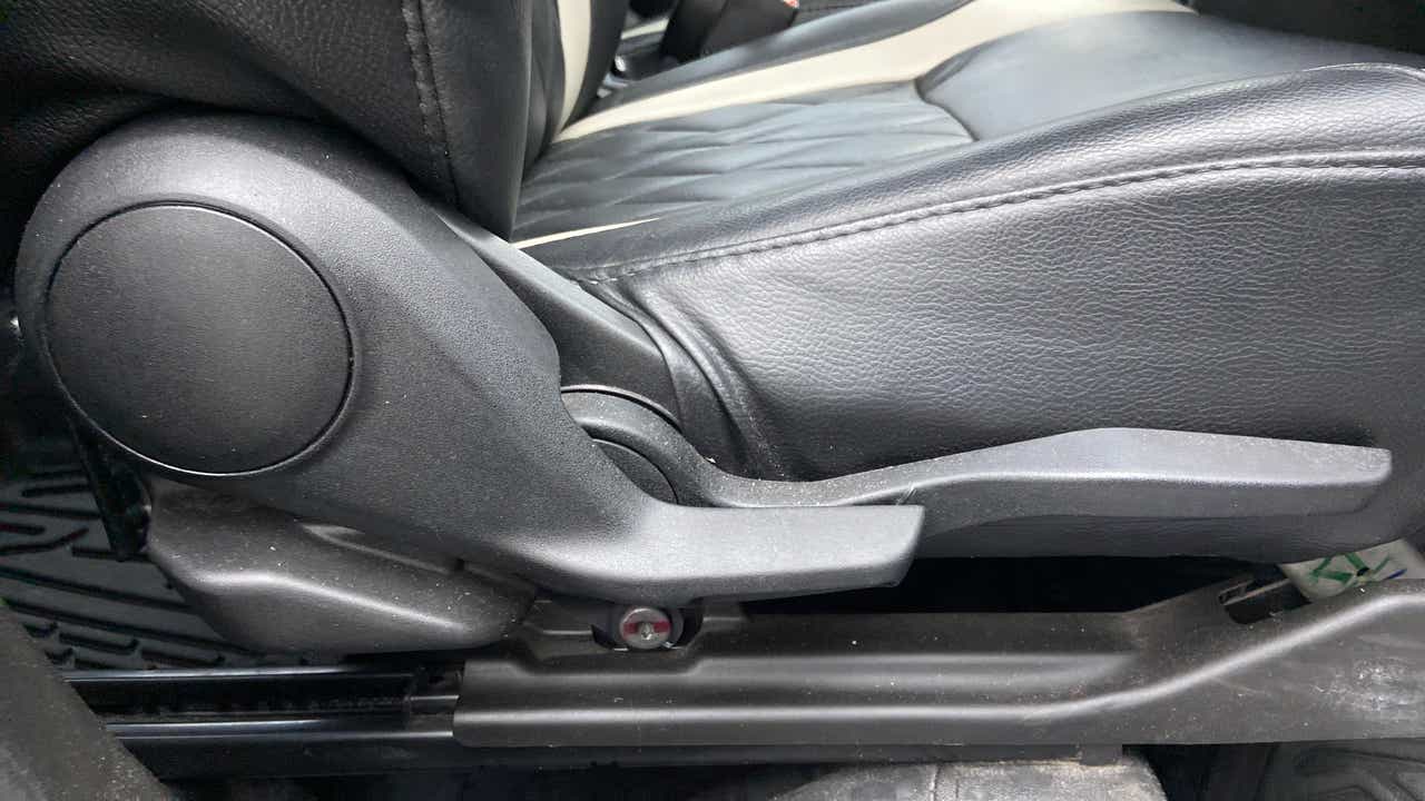 Seat height adjuster lever close-up of a Maruti Suzuki Brezza