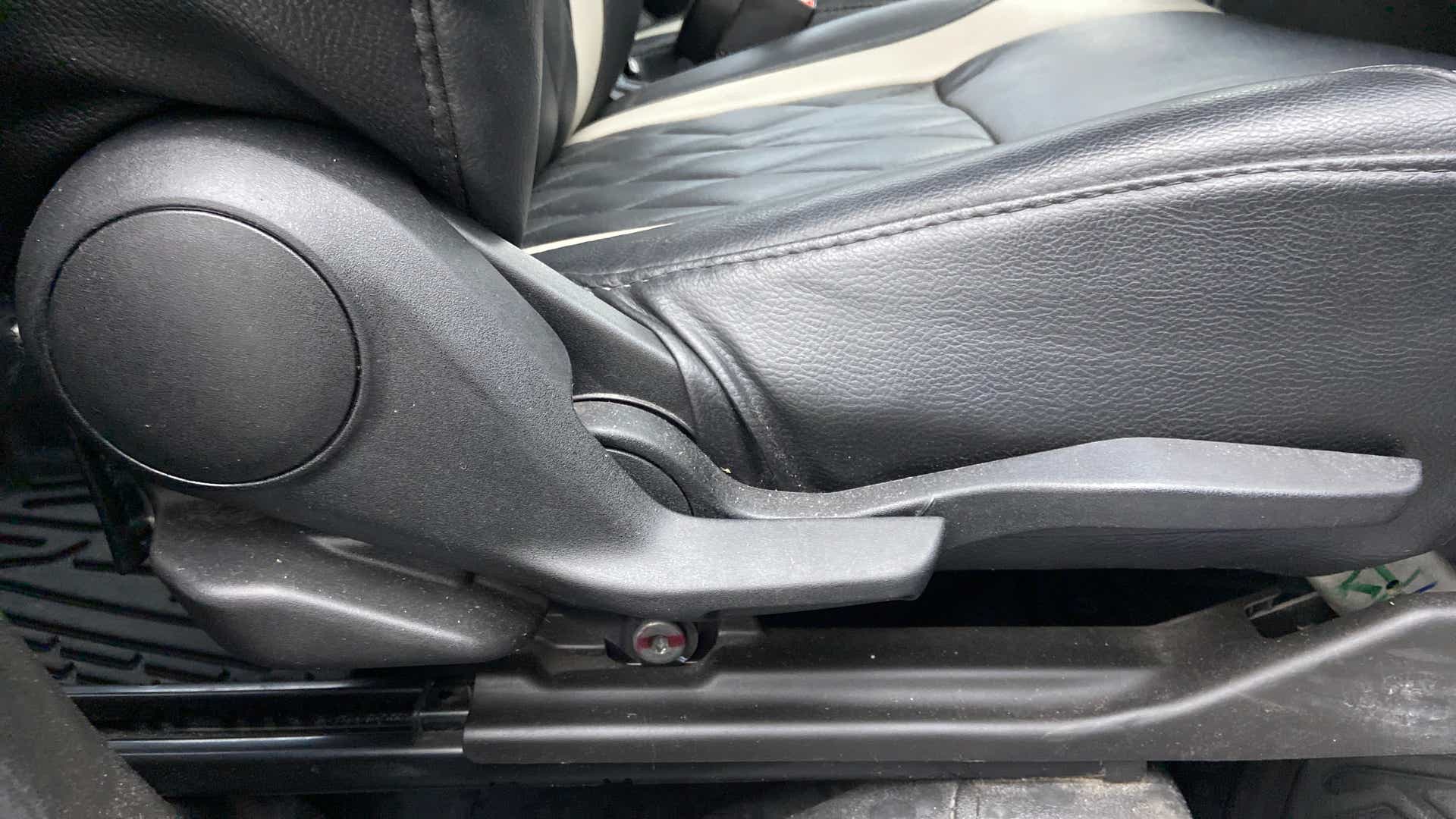 Seat height adjuster lever close-up of a Maruti Suzuki Brezza