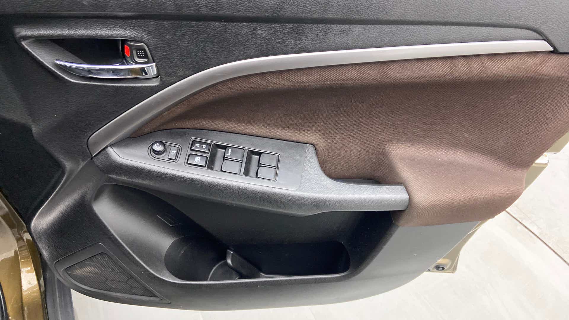 Driver side interior door panel of a Maruti Suzuki Brezza