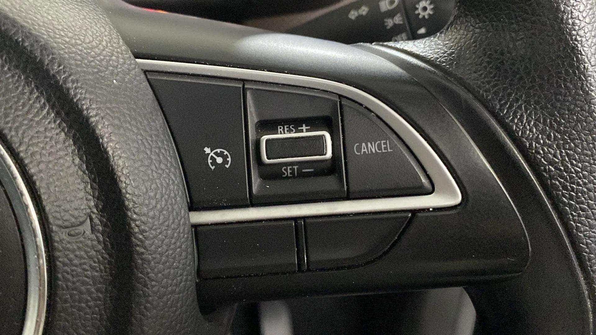 Steering wheel cruise control buttons of a Maruti Suzuki Brezza