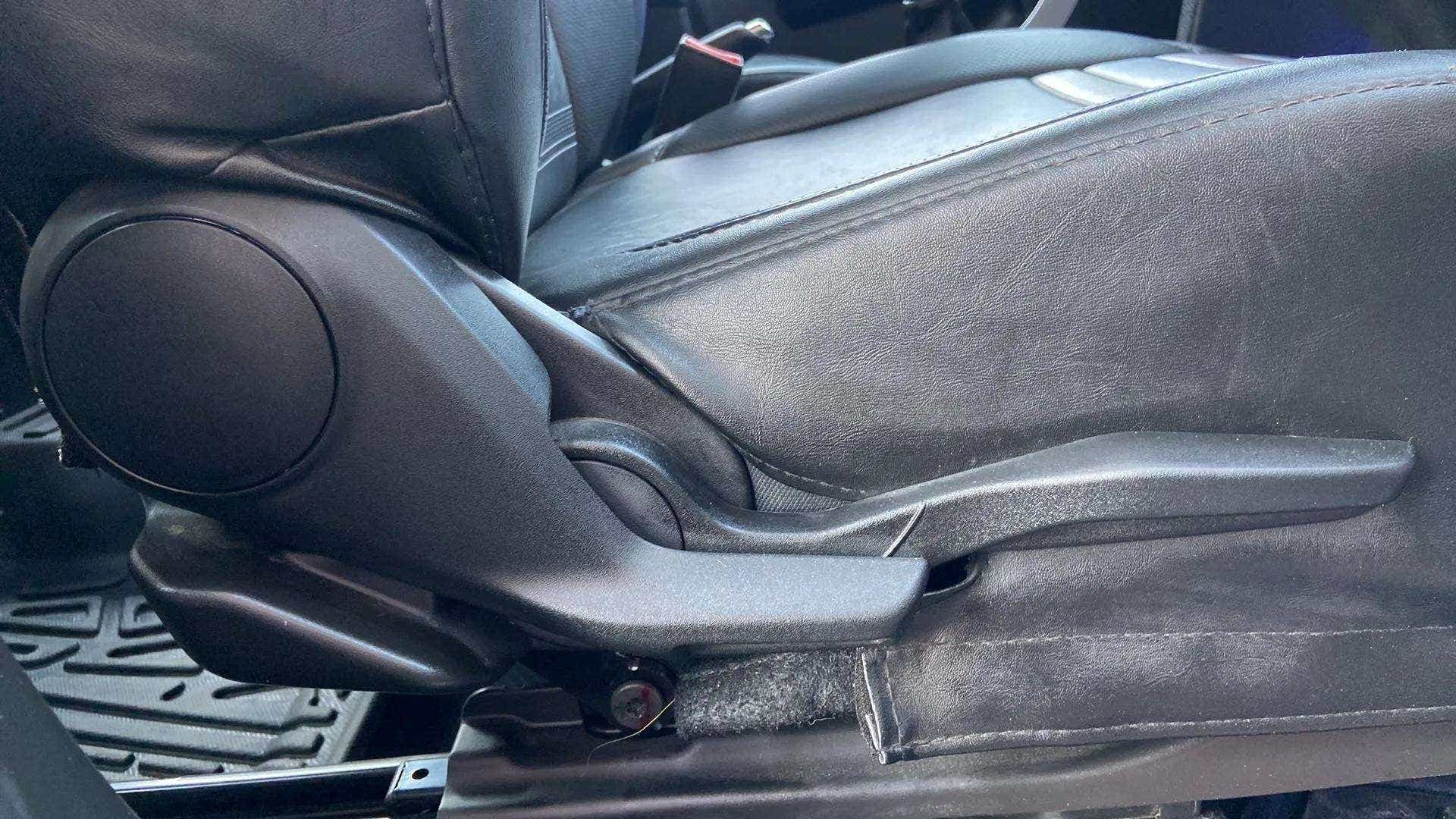 Side view of a Maruti Suzuki Brezza car seat adjustment lever