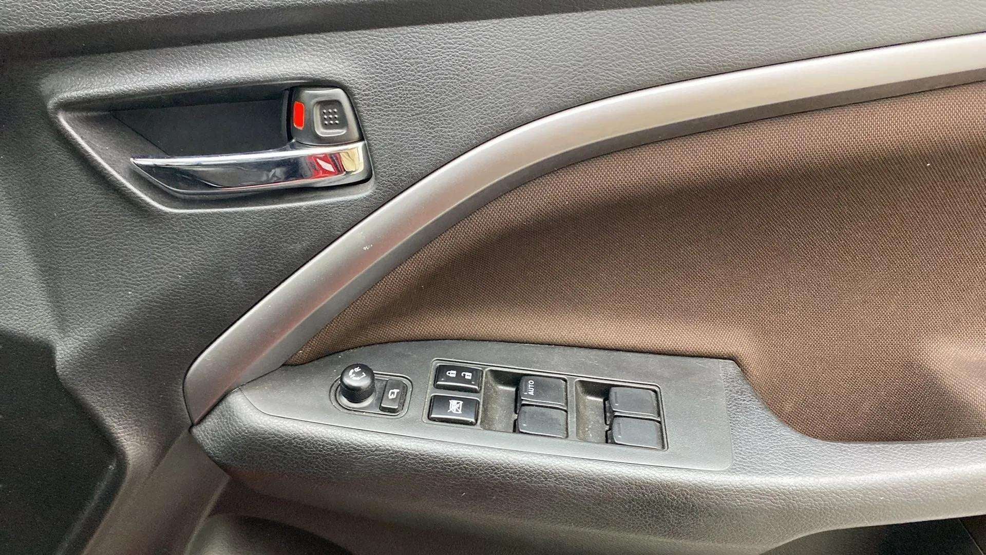 Interior driver-side door controls of a Maruti Suzuki Brezza