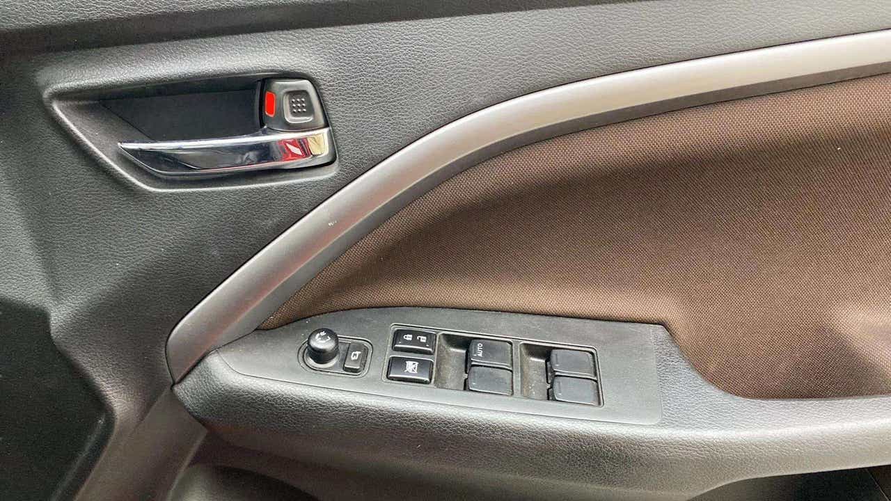 Interior driver-side door controls of a Maruti Suzuki Brezza