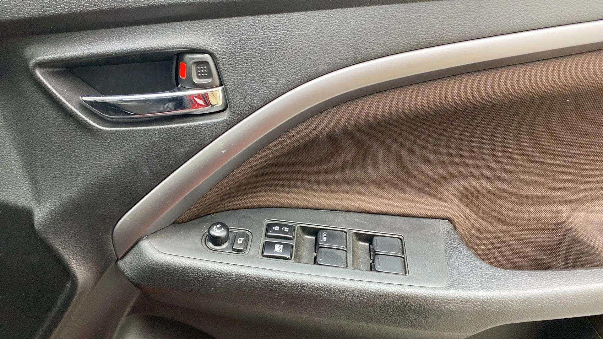 Interior driver-side door controls of a Maruti Suzuki Brezza