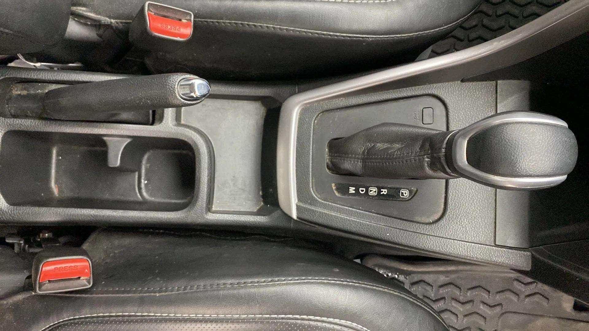 Gear shifter and handbrake area of a Maruti Suzuki Brezza