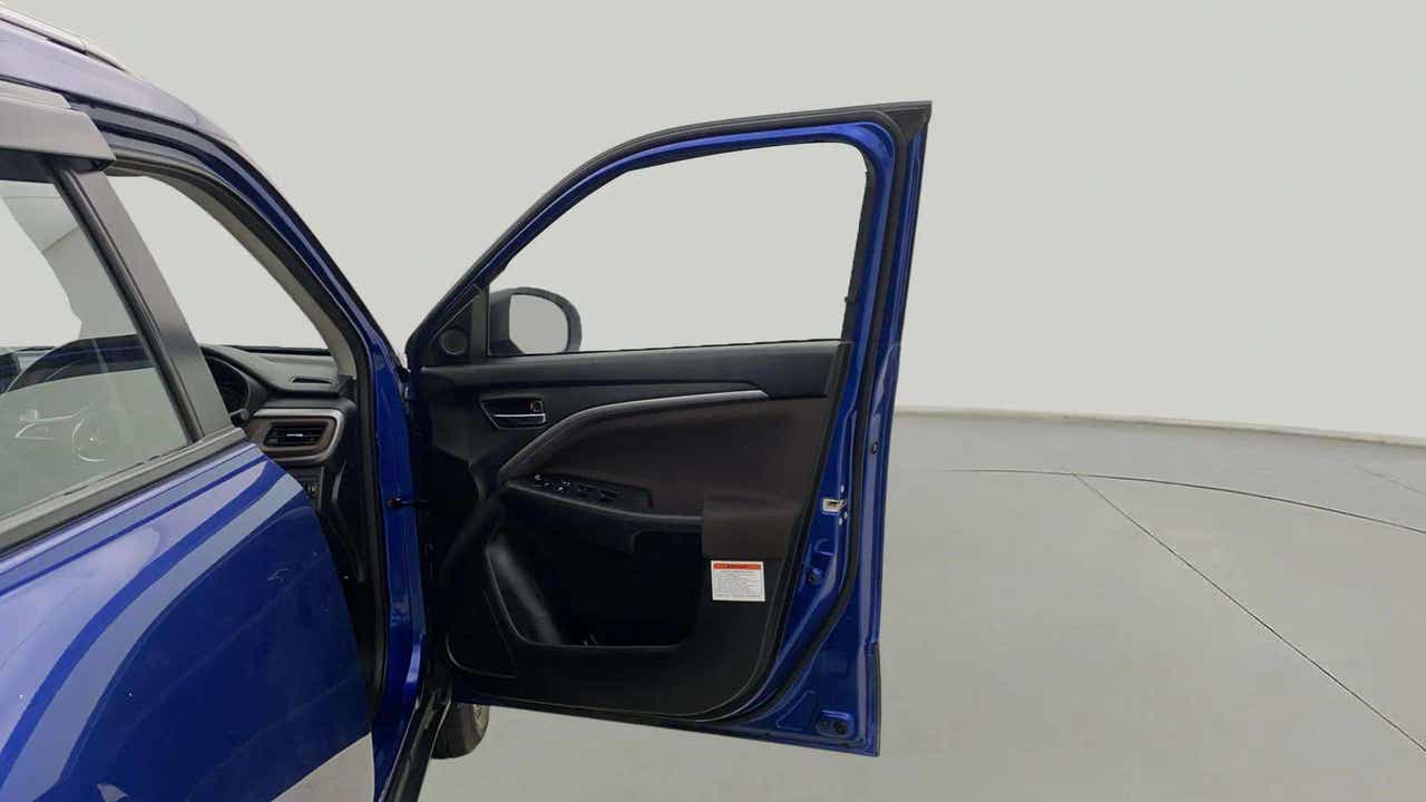 Driver-side open door view of a Maruti Suzuki Brezza