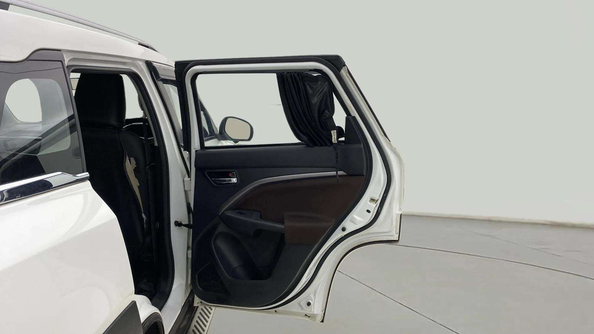 Rear left door open view of a Maruti Suzuki Brezza