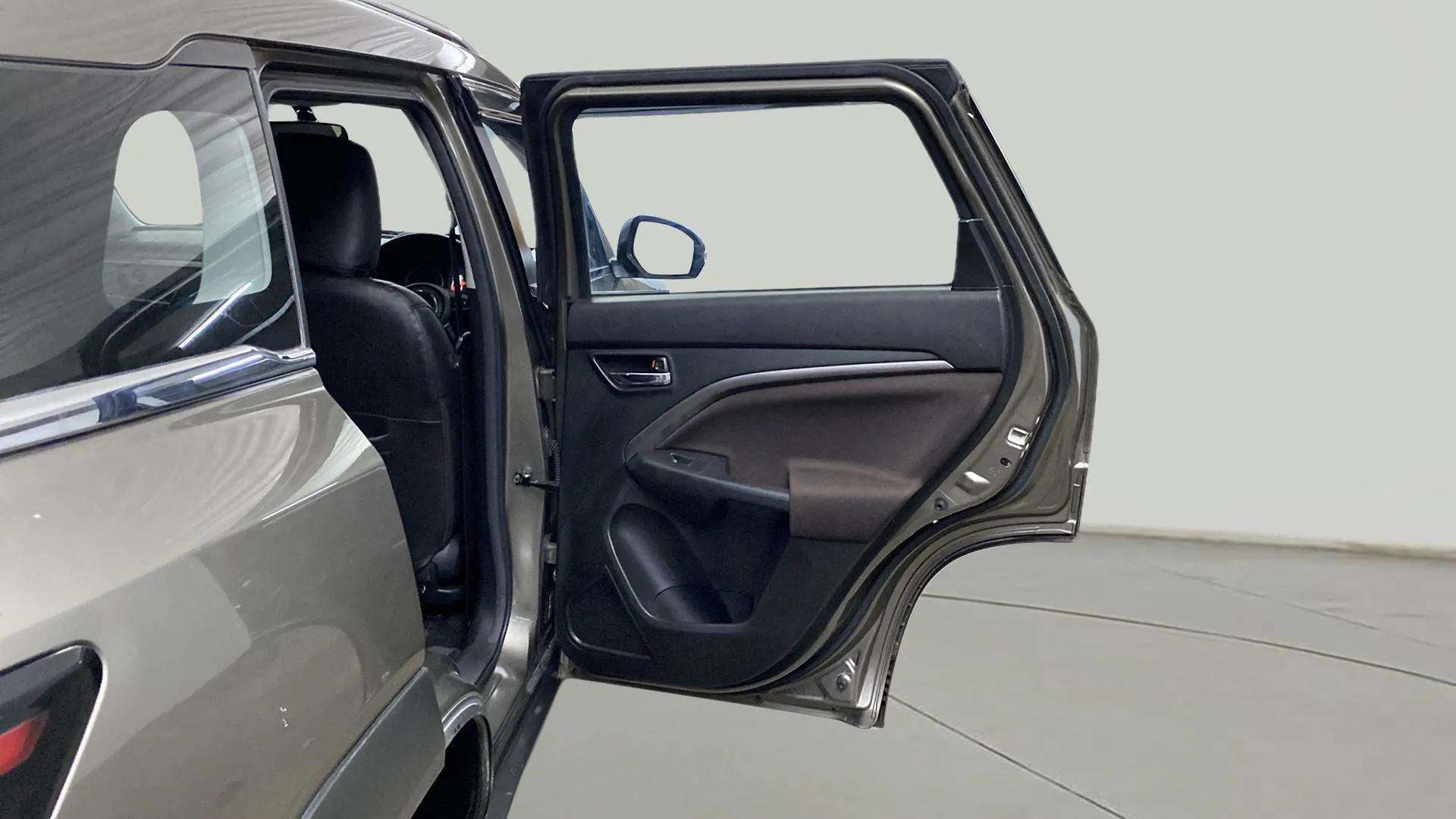 Rear passenger door open view of a Maruti Suzuki Brezza