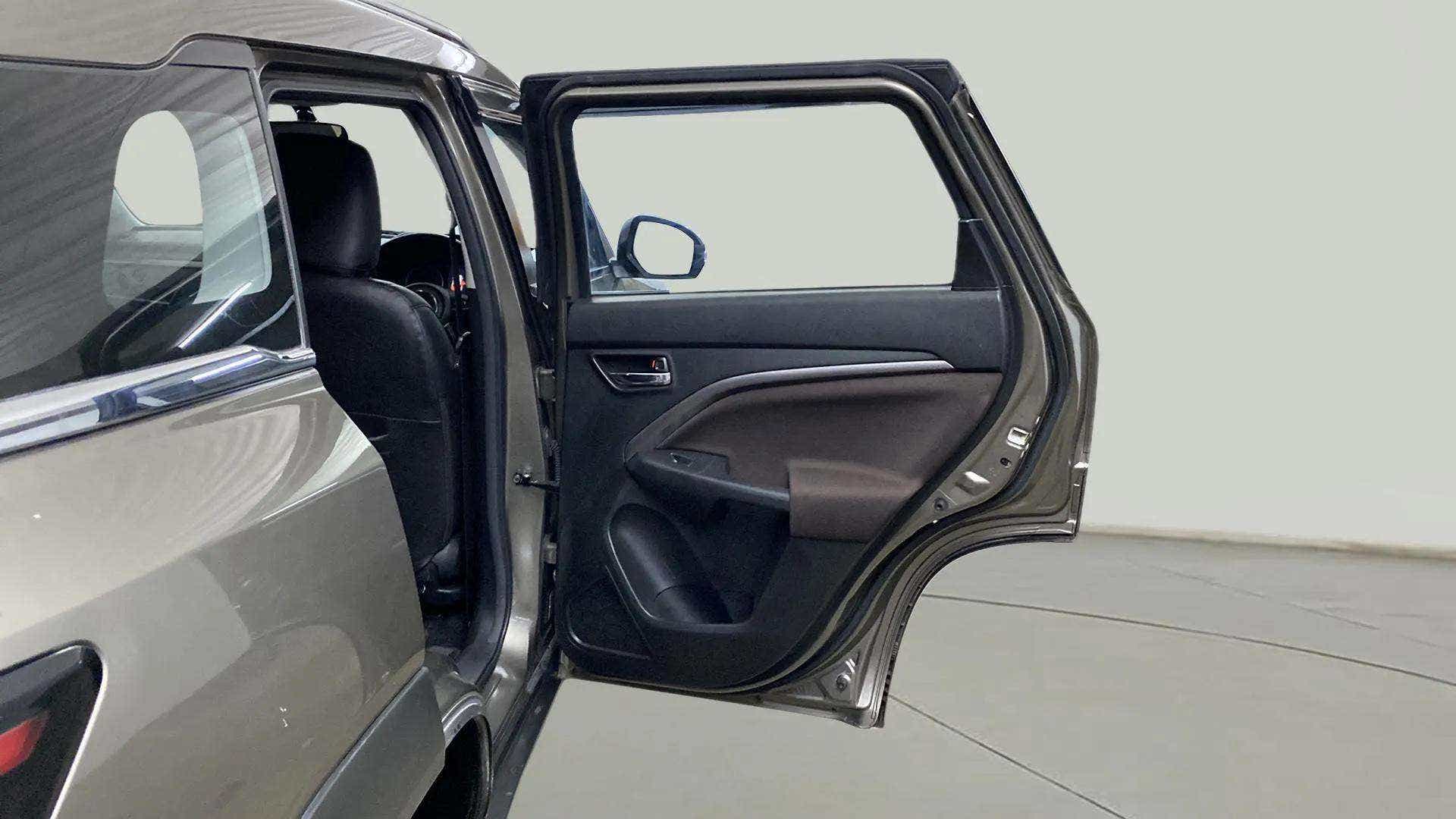 Rear passenger door open view of a Maruti Suzuki Brezza