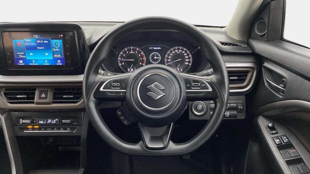 Interior dashboard and steering wheel of a Maruti Suzuki Brezza