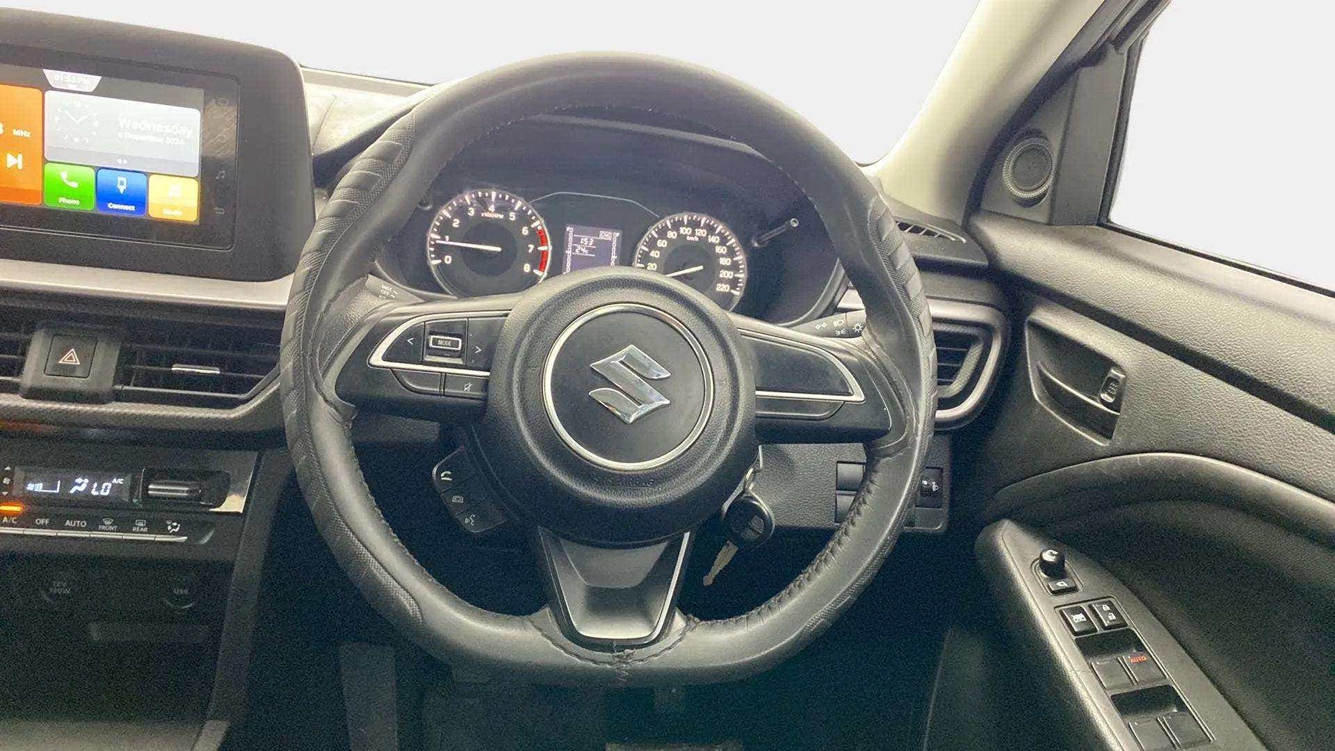 Interior driver cockpit view of a Maruti Suzuki Brezza