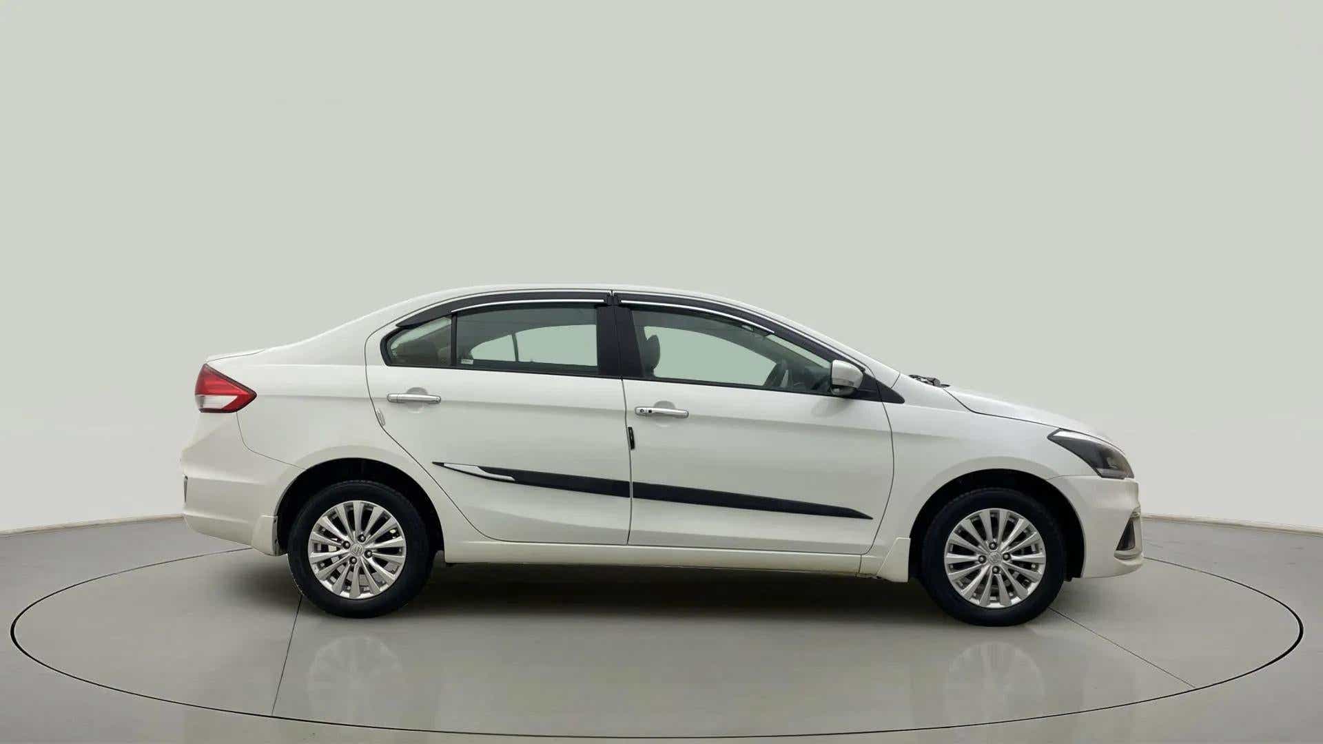 Side view of a Pearl Arctic White Maruti Suzuki Ciaz