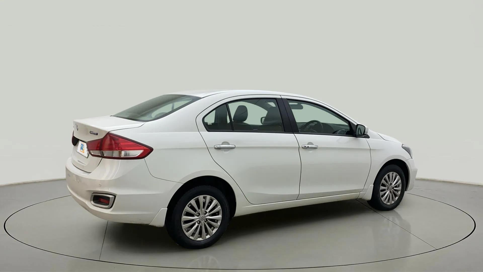 Rear three-quarter of a Pearl Arctic White Maruti Suzuki Ciaz