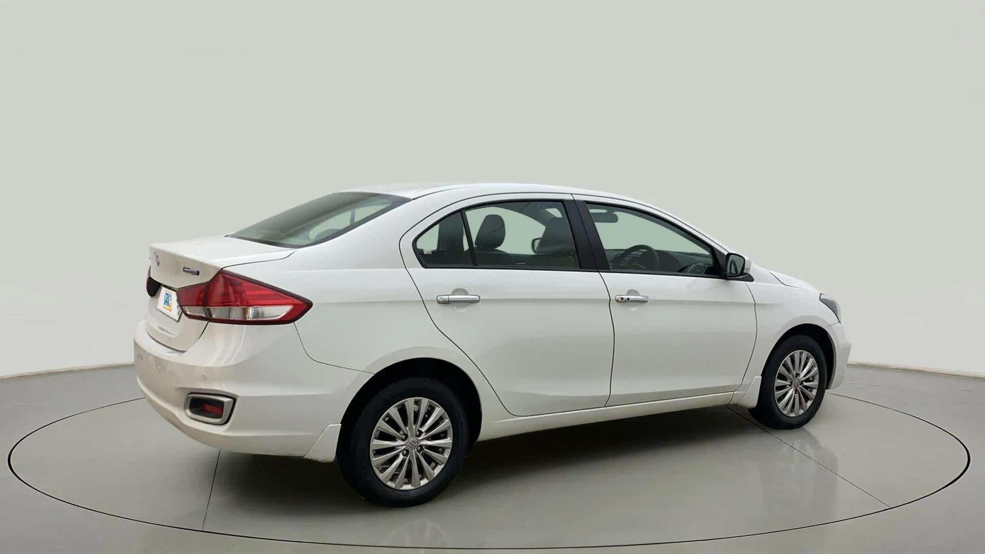 Rear three-quarter of a Pearl Arctic White Maruti Suzuki Ciaz