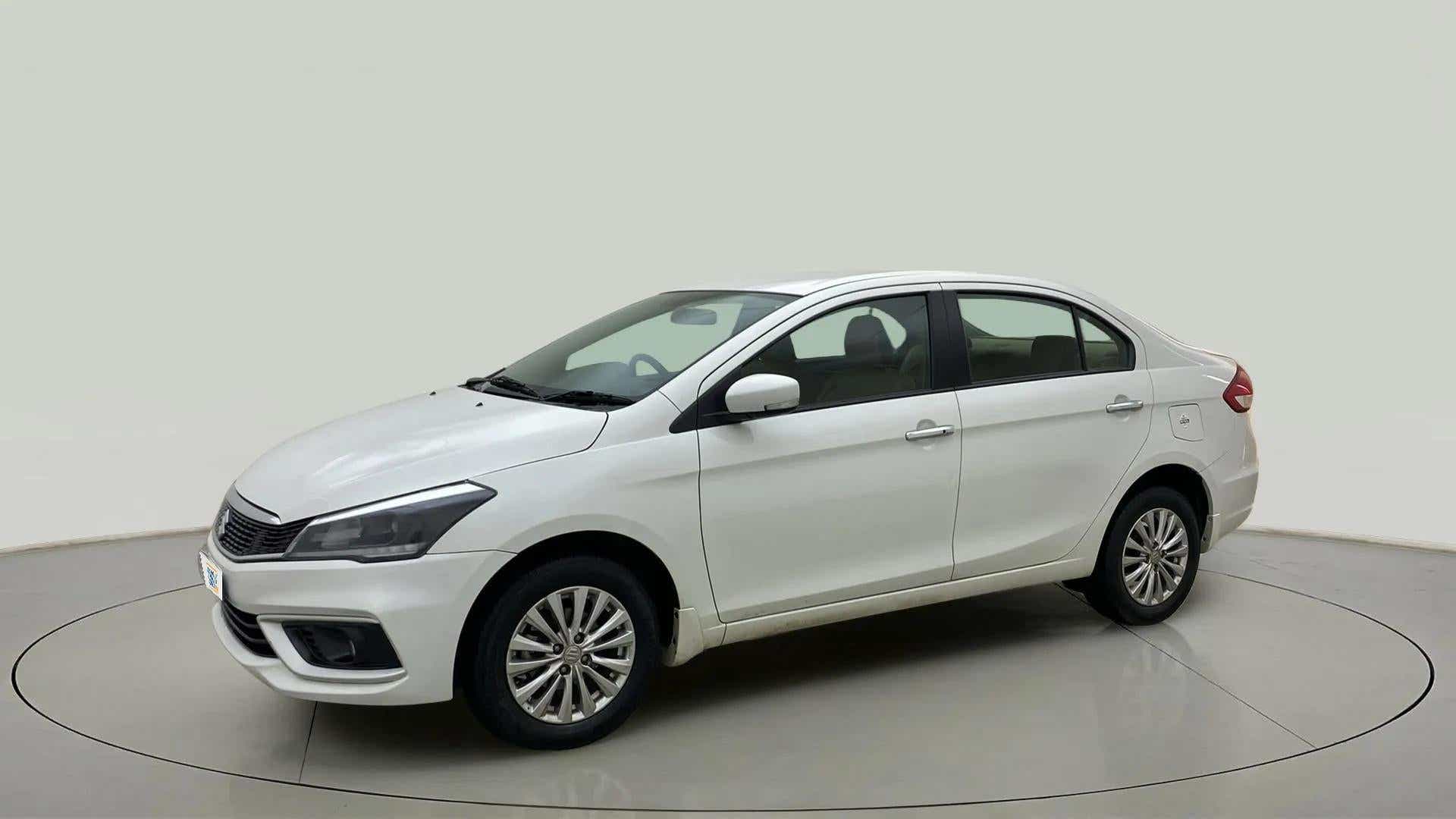 Front three-quarter view of a Pearl Arctic White Maruti Suzuki Ciaz