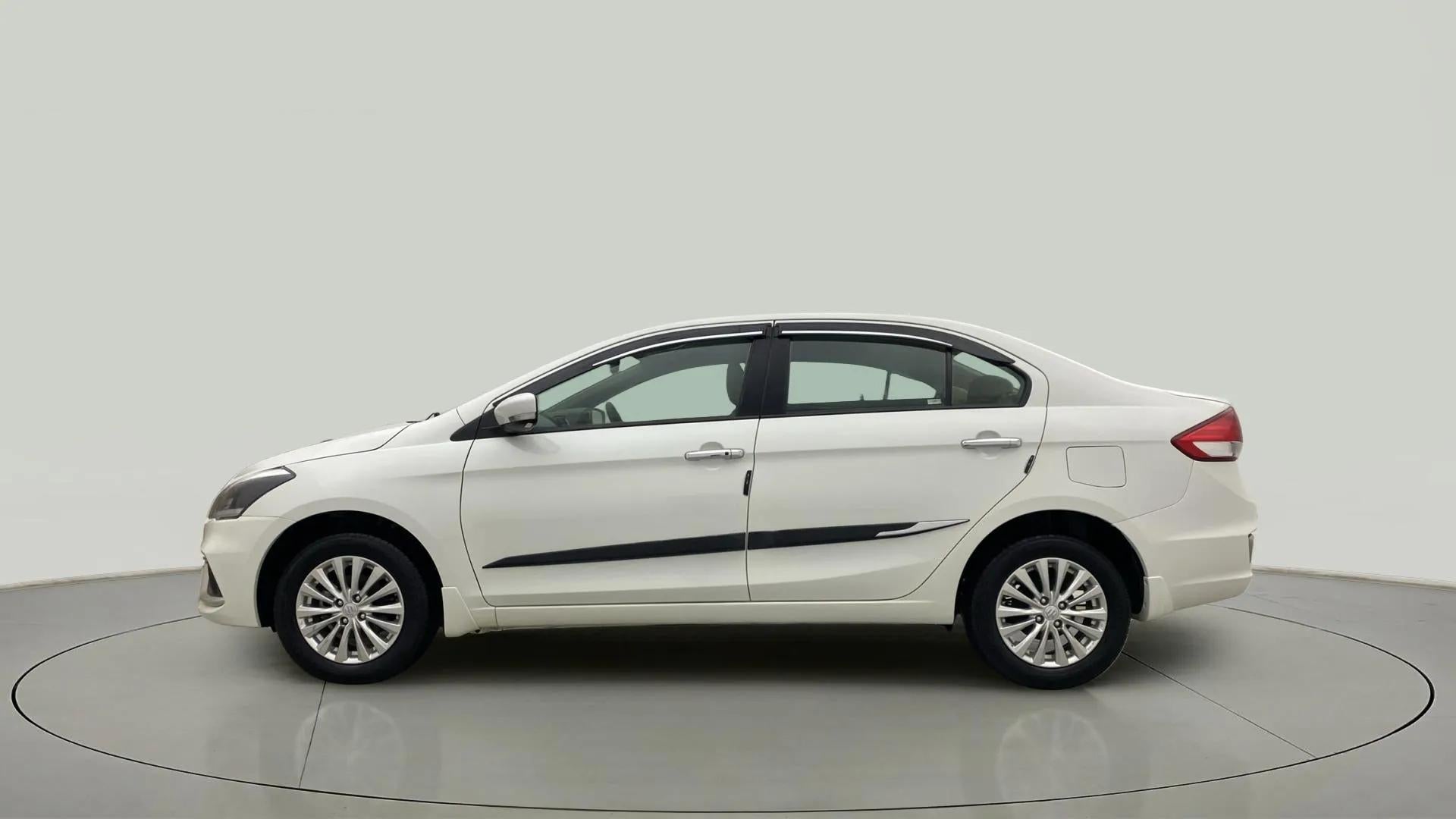 Side view of a Pearl Arctic White Maruti Suzuki Ciaz
