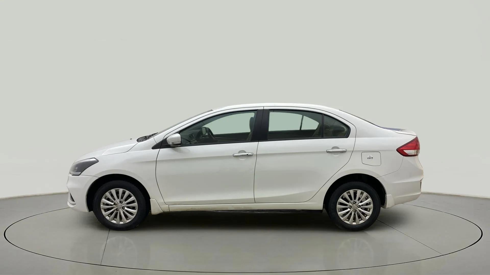 Side view of a Pearl Arctic White Maruti Suzuki Ciaz