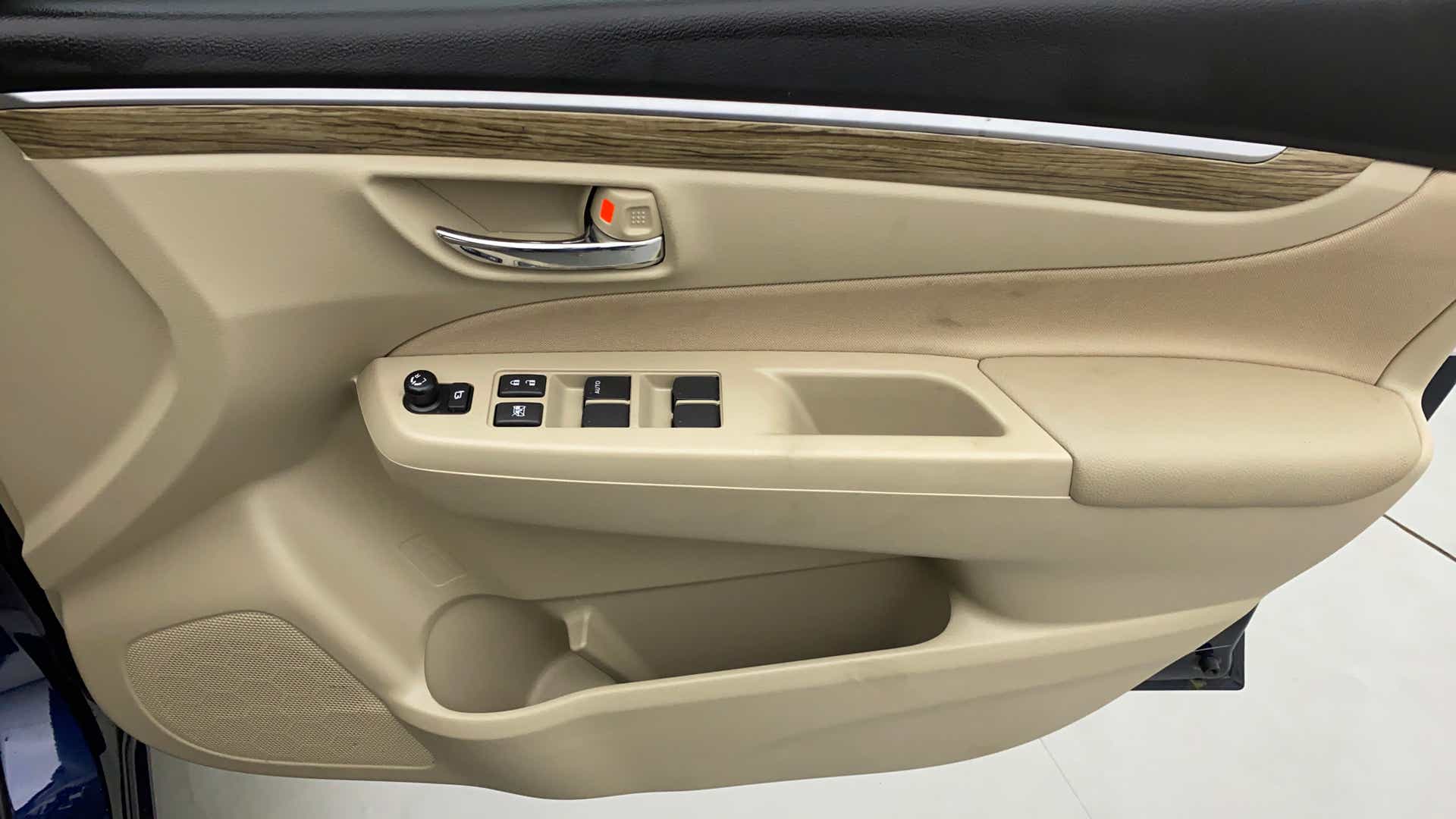 Interior driver-side door panel of a Maruti Suzuki Ciaz