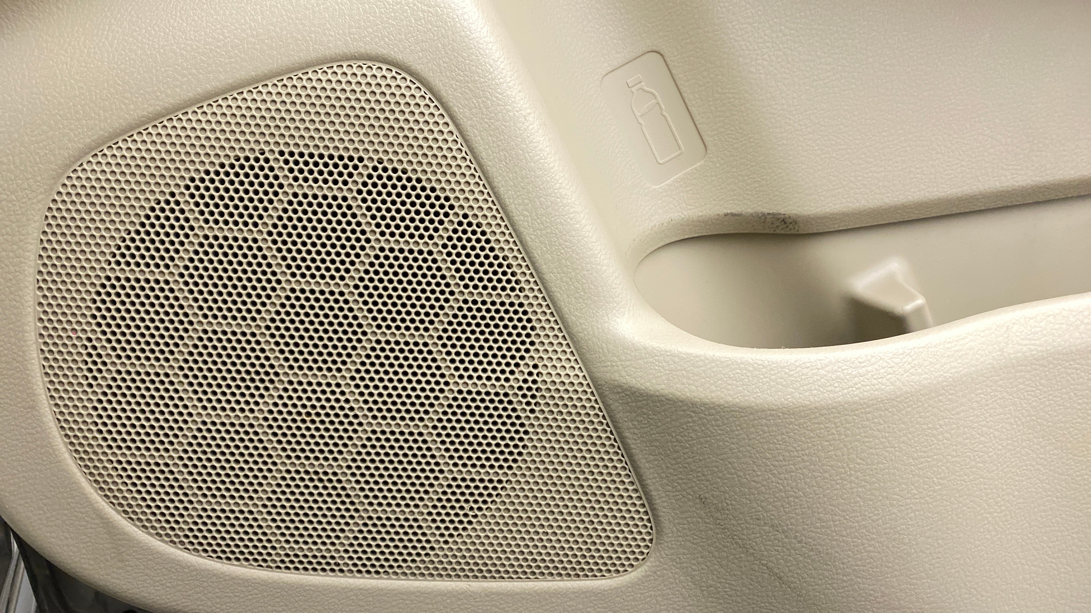 Car door speaker grille and bottle holder of a Maruti Suzuki Ciaz