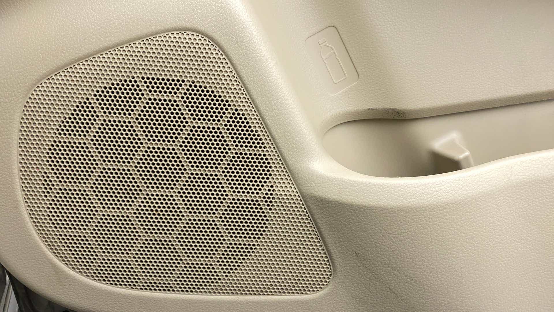 Car door speaker grille and bottle holder of a Maruti Suzuki Ciaz