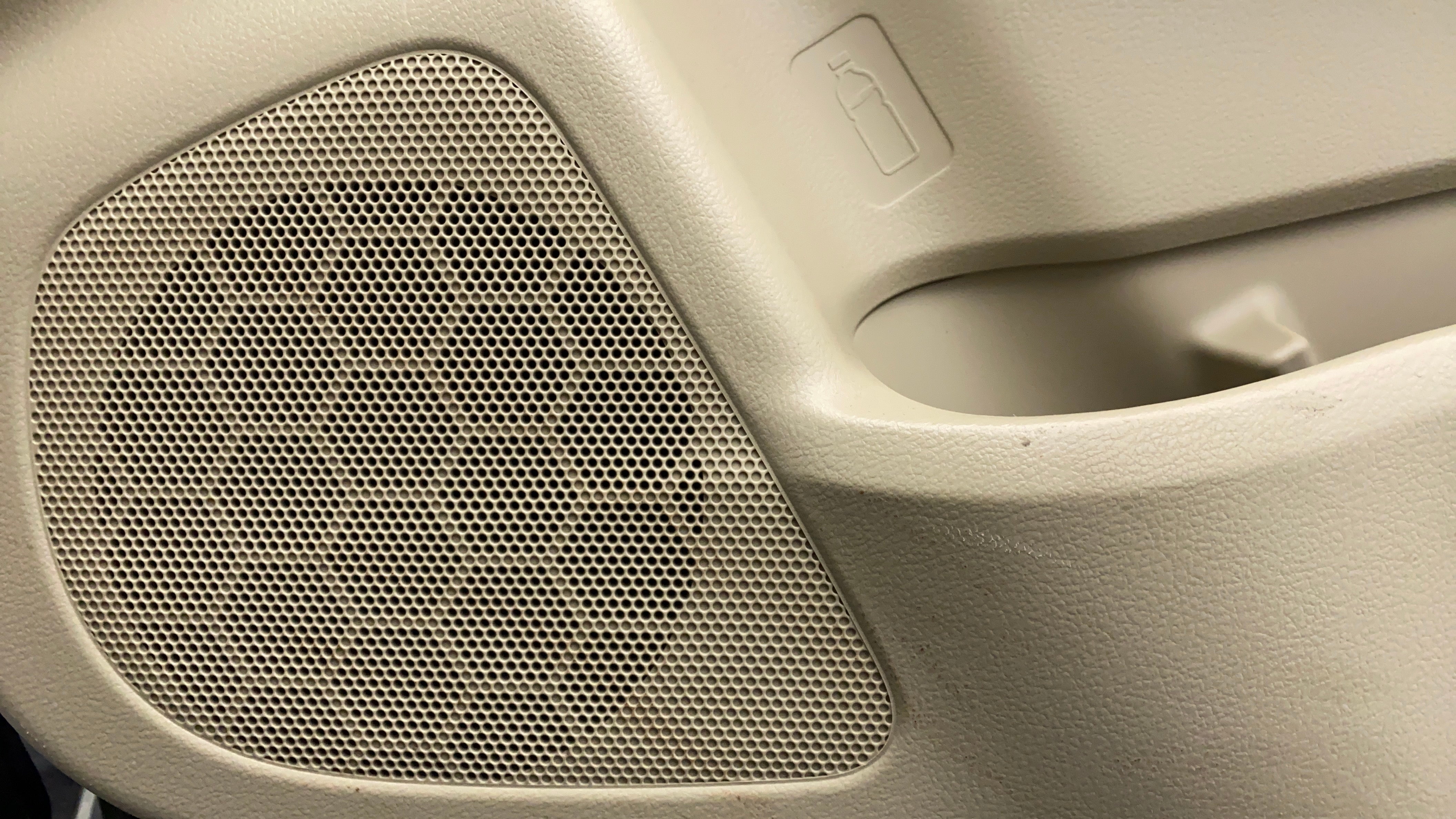 Close-up of speaker grille and bottle holder in a Maruti Suzuki Ciaz