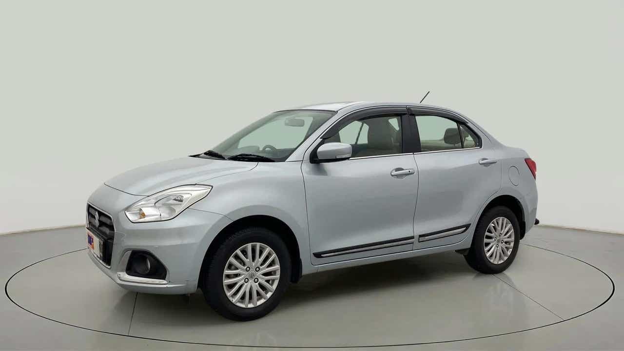 Front and side view of a Splendid Silver Maruti Suzuki Dzire