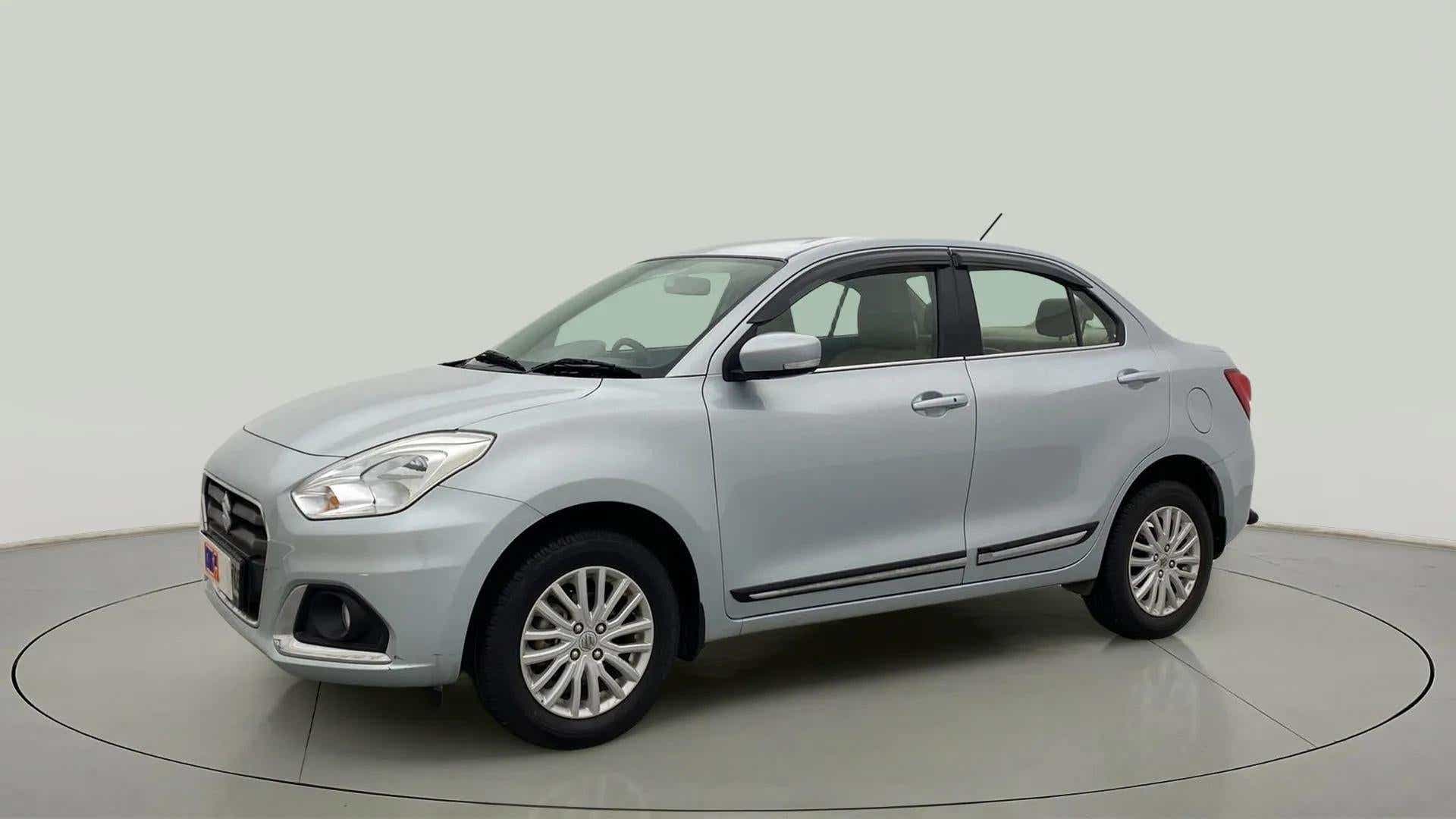 Front and side view of a Splendid Silver Maruti Suzuki Dzire