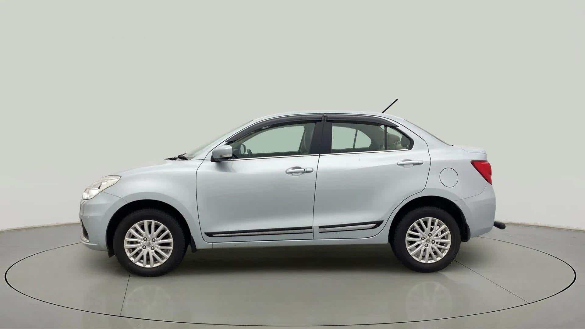 Side view of a splendid silver Maruti Suzuki Dzire