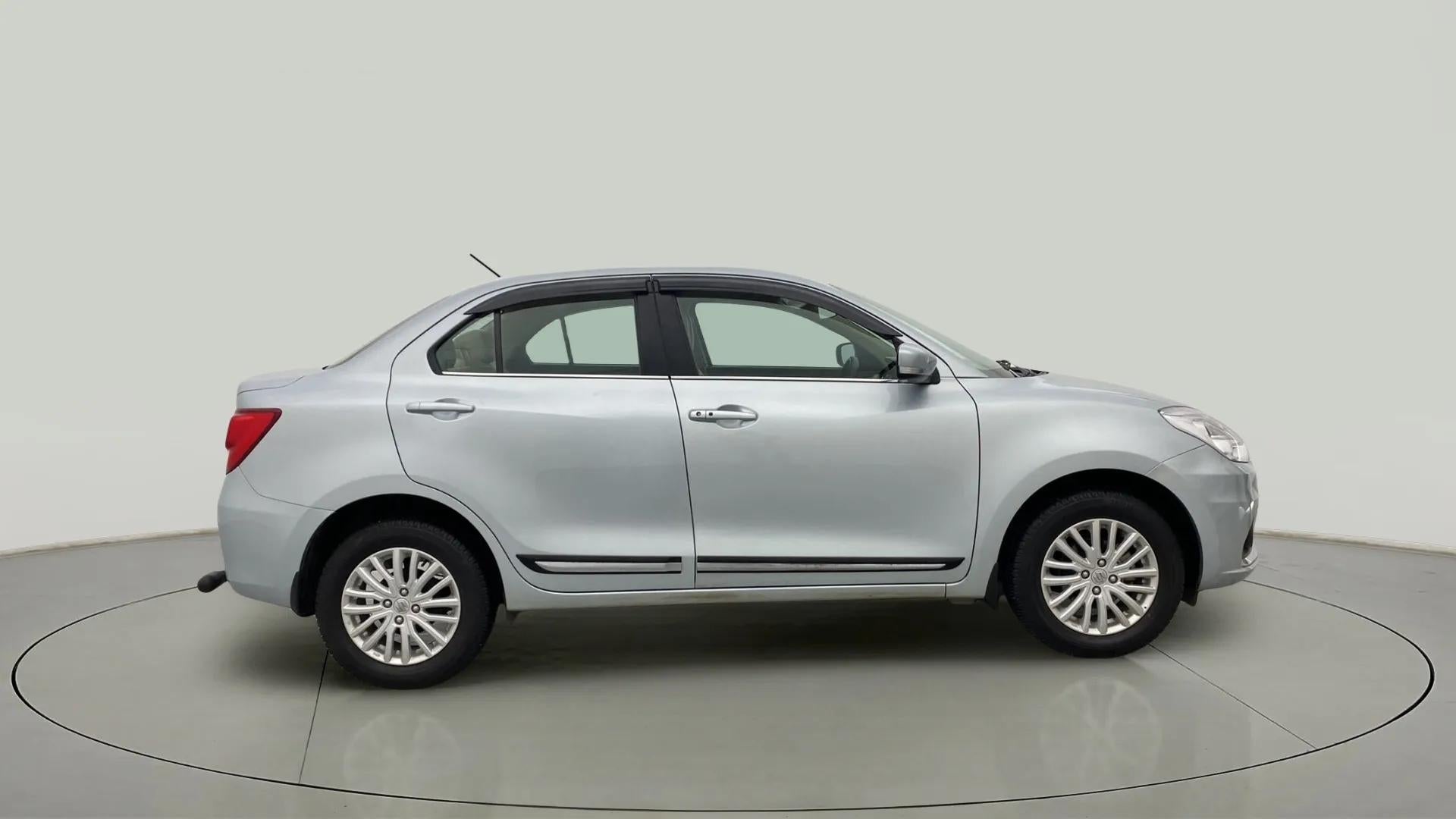 Side view of a Splendid Silver Maruti Suzuki Dzire