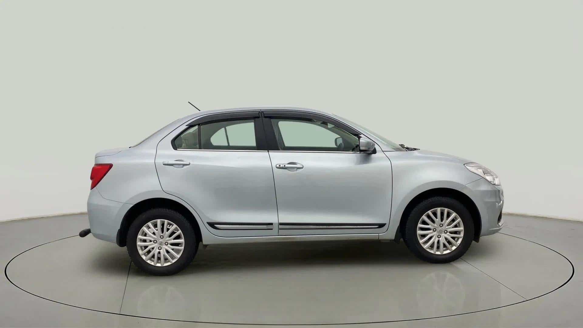 Side view of a Splendid Silver Maruti Suzuki Dzire