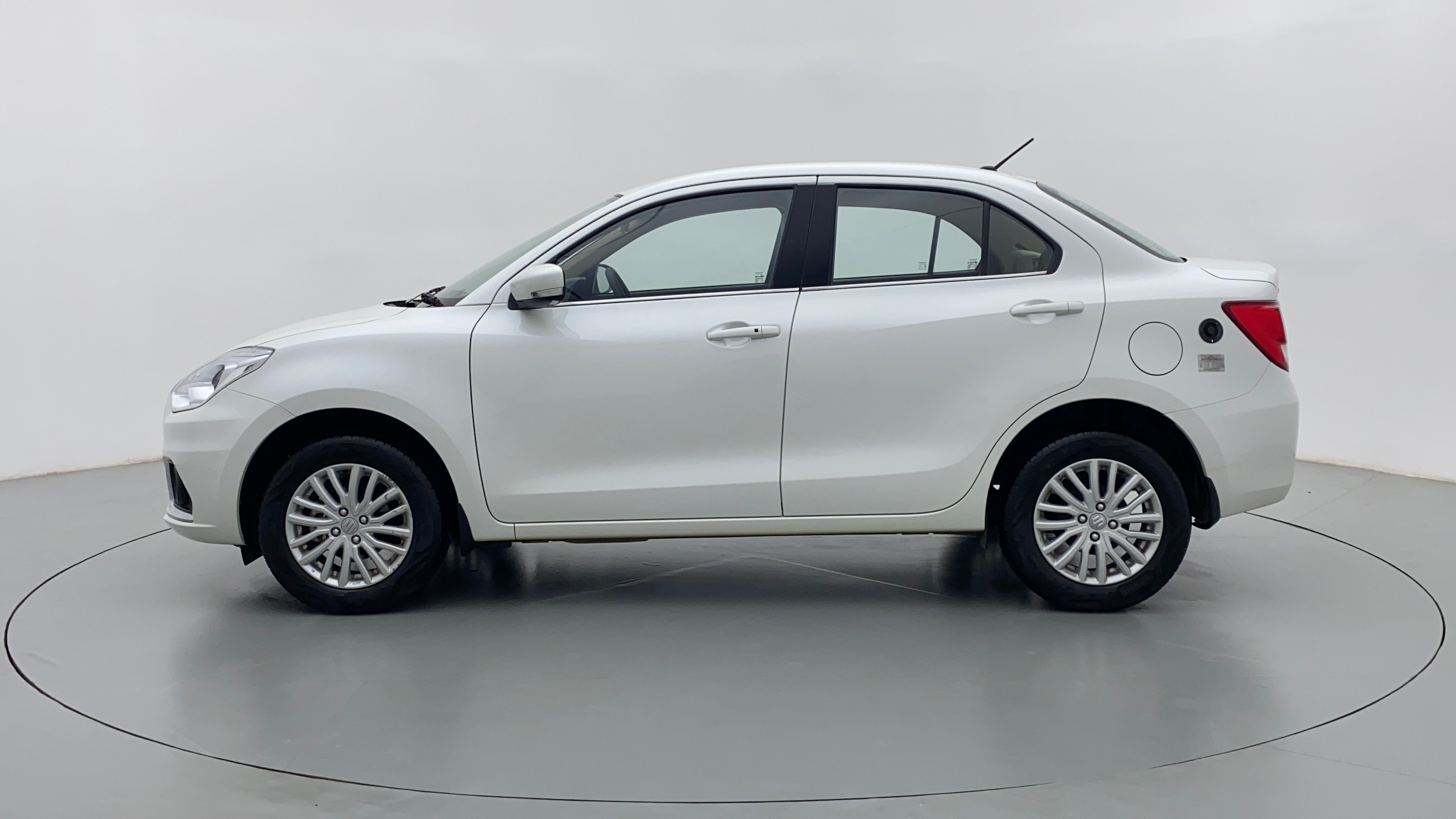 Side view of a arctic white Maruti Suzuki Dzire 2018-2023