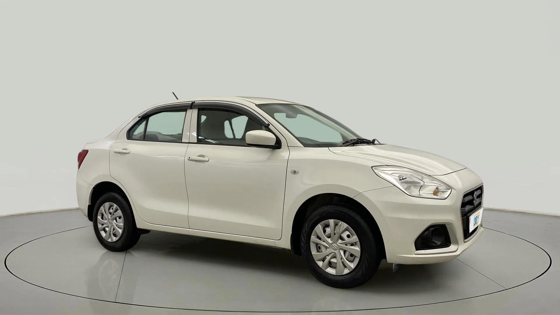 Front and side view of a pearl arctic white Maruti Suzuki Dzire