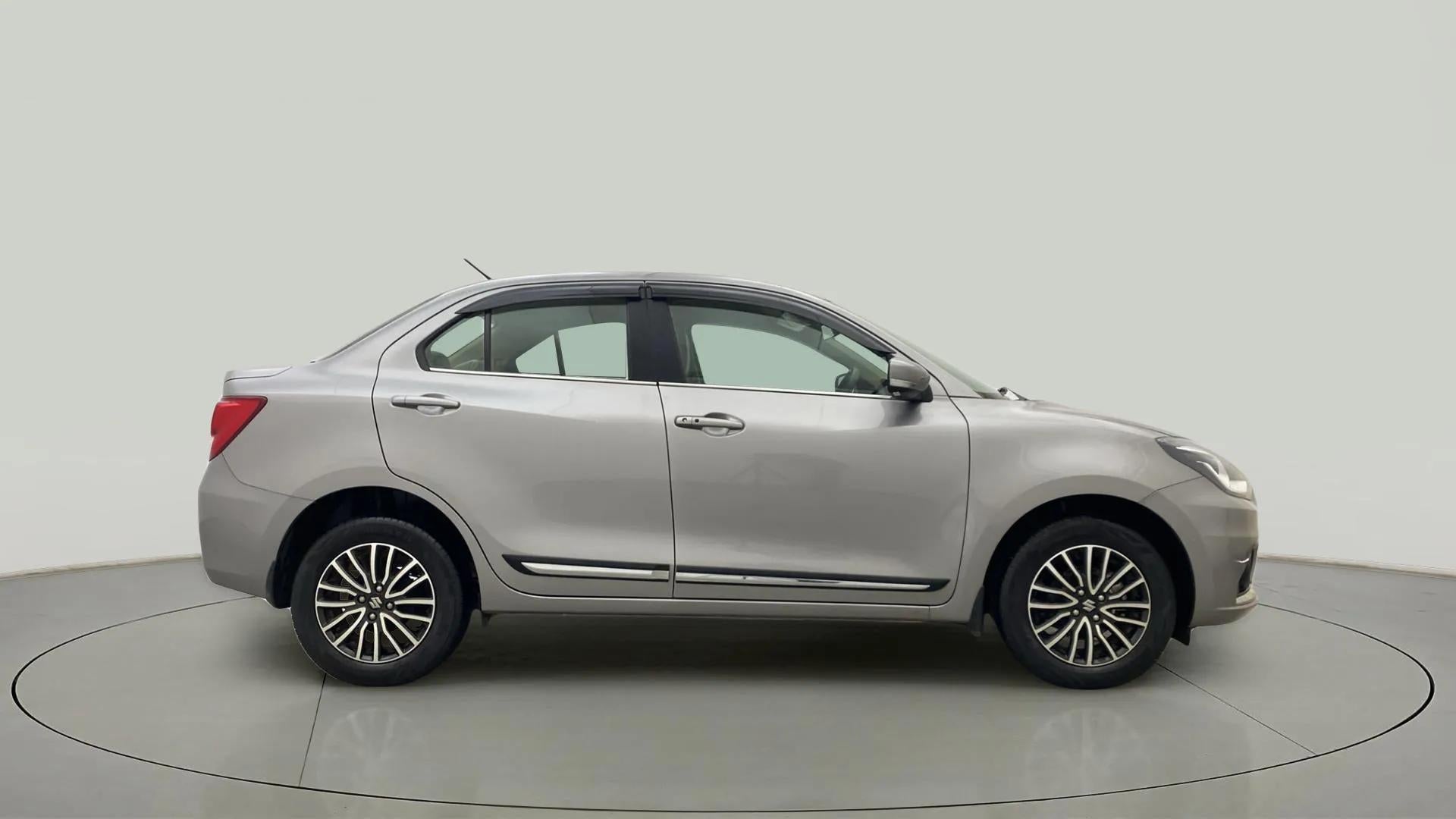 Side view of a splendid silver Maruti Suzuki Dzire 2018-2023