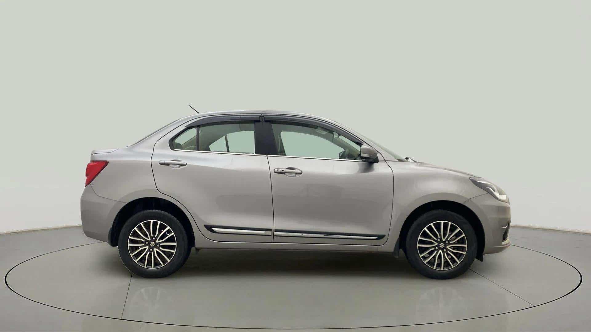 Side view of a splendid silver Maruti Suzuki Dzire 2018-2023