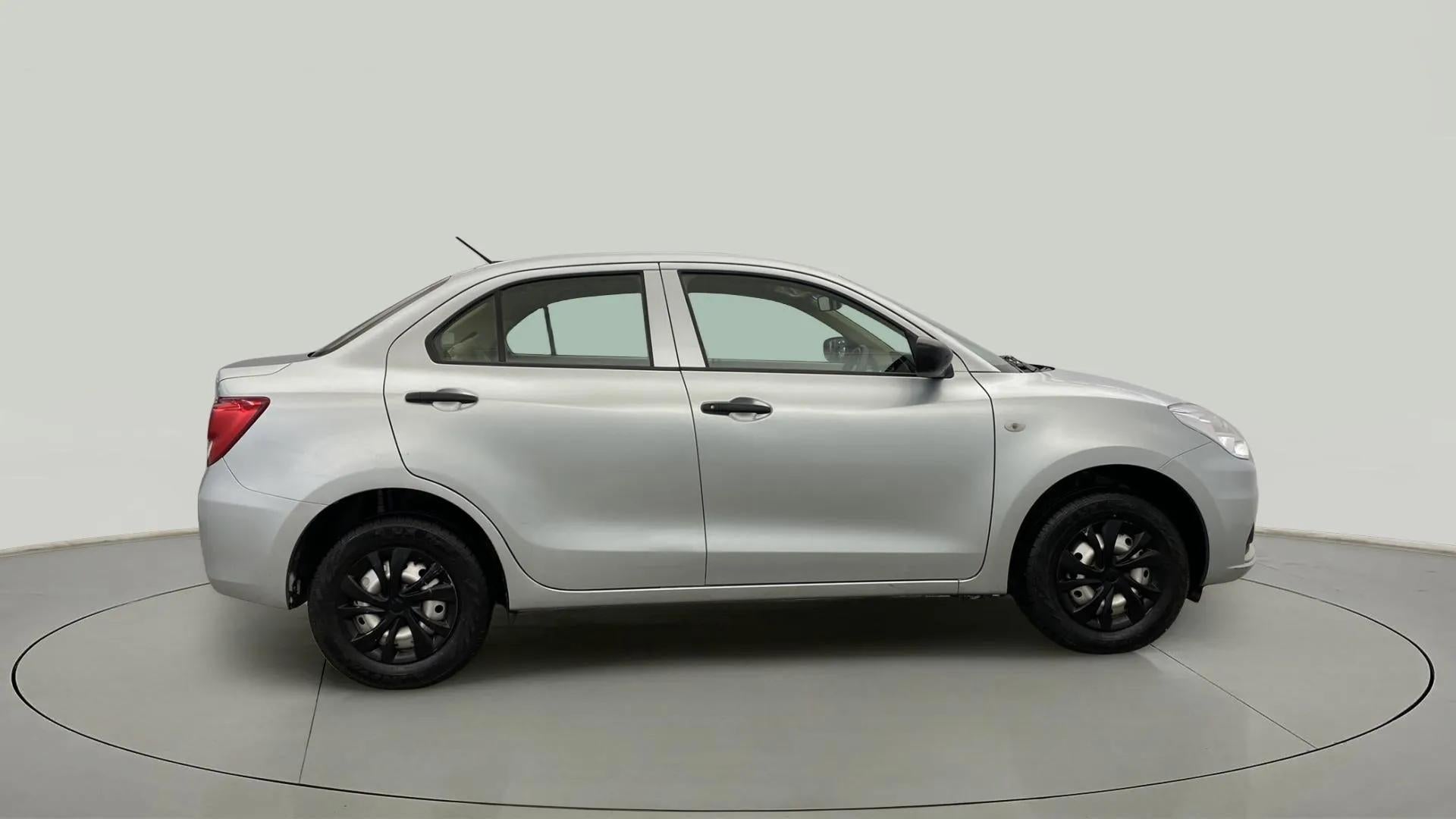 Side view of a Splendid Silver Maruti Suzuki Dzire 2018-2023
