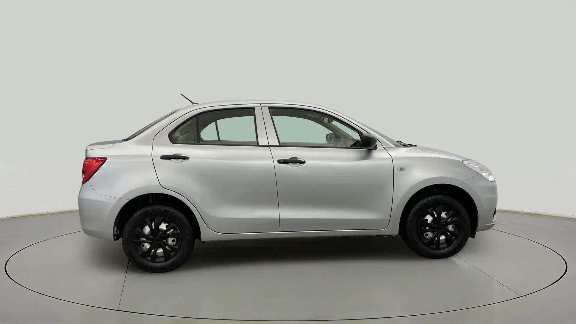 Side view of a Splendid Silver Maruti Suzuki Dzire 2018-2023