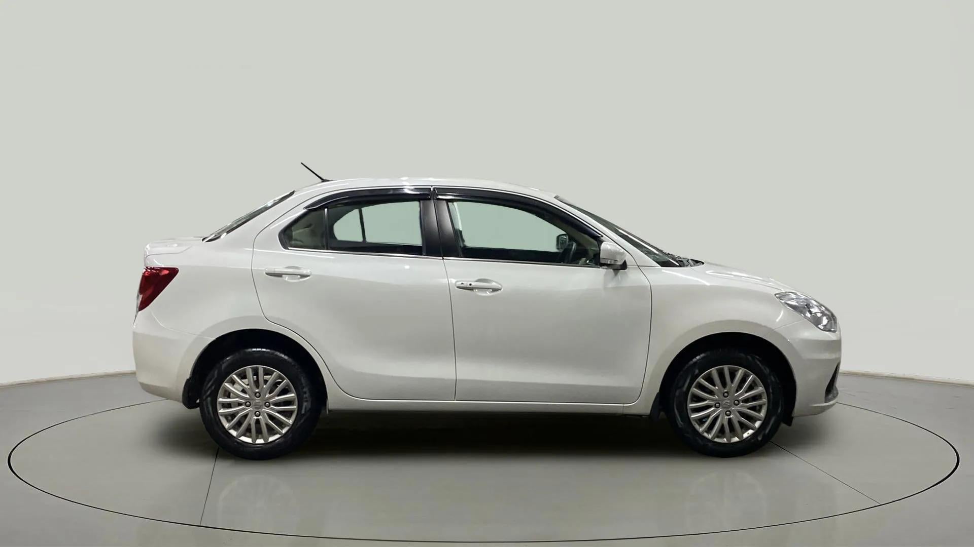 Side view of a Arctic White Maruti Suzuki Dzire 2018-2023